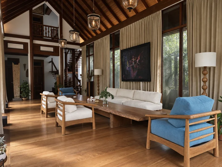 A living room with hardwood seating, a live-edge table, tall windows and a pitched timber ceiling