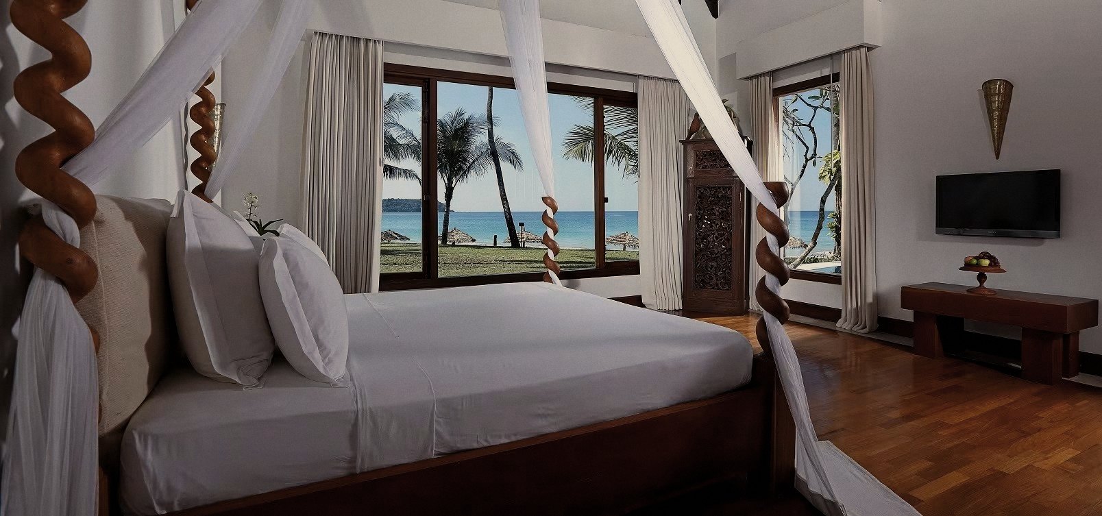 Ngapali Bay villa bedroom with four-poster and sea view
