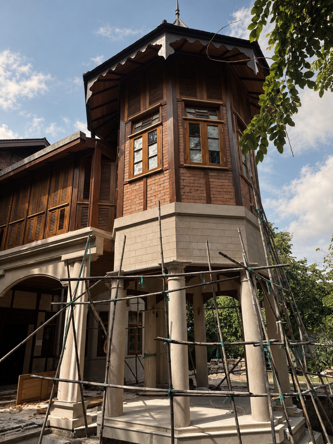 Teak house under construction with scaffolding